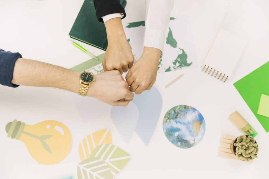 group-businesspeople-fist-bumping-desk